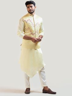 This Yellow Gujarati Work Nehru Jacket will instantly give an elegant look. This Yellow Nehru Jacket features in linen satin fabric with Gujarati stitch work detail on the front, mirror embroidery, invisible front button placket, and a mandarin collar. An ideal outfit for traditional occasions, and special events.

Size Chart For Men





	
	
					Men's Size Chart
		

		
		
						
				Size Chart For Men
				Custom Size Measurement Guide
			
			
				
				
				Custom Size Measurement Guide
1. Take Tailored Luxury Nehru Jacket For Festive Occasions, Luxury Gold Nehru Jacket For Semi-formal Occasions, Luxury Cream Nehru Jacket, Luxury Raw Silk Nehru Jacket With Traditional Drape, Luxury Multicolor Bollywood Nehru Jacket, Luxury Classic Nehru Jacket With Buttons, Luxury Yellow Designer Nehru Jacket, Luxury Unstitched Cotton Silk Nehru Jacket, Luxury Cream Raw Silk Nehru Jacket