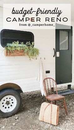 a brown chair sitting in front of a black door and a white trailer with a potted plant on it