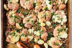 a pan filled with meat and vegetables covered in seasoning