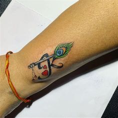 a woman's arm with a tattoo on it that has an arrow and heart