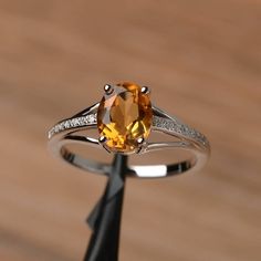 It is a natural citrine ring. The main stone is 7mm*9mm oval cut, weight about 1.77 carats.The basic metal is sterling silver and plated with rhodium.To change the metal to a solid gold (white/rose) or platinum is also available, please ask for a quotation if you want.You can also go to my shop Home for more elegant rings: https://www.etsy.com/shop/godjewelry?ref=hdr_shop_menuMore rings:https://www.etsy.com/shop/godjewelry?ref=l2-shop-header-avatarCustomization is always welcome and please feel Yellow Citrine Ring, Citrine Ring Engagement, November Birthstone Ring, Oval Cut Ring, Yellow Gemstones, Citrine Ring, Citrine Crystal, Natural Citrine, November Birthstone