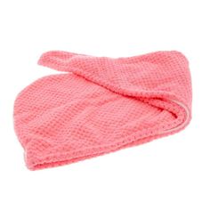 a pink towel is folded up on a white surface