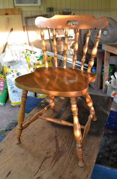 a wooden chair sitting on top of a table