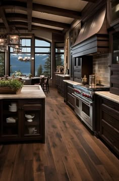 a large kitchen with wooden floors and dark cabinets