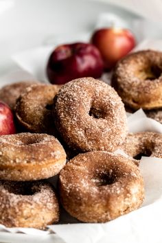 there are many donuts and apples on the plate