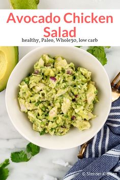 avocado chicken salad in a white bowl with cilantro on the side