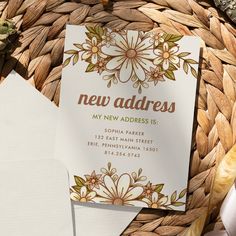 a new address card on top of a basket next to some papers and other items