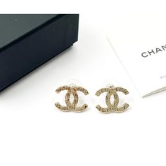 This is part of Chairish’s Costume Jewelry assortment.  Chanel Gold CC Hieroglyphs Piercing Earrings  *Marked 19 *Made in France *Comes with the original box, pouch and booklet  -It is approximately 0.75" x 0.5". -In a pristine condition High-end Gold Earrings For Gift, Gold Jewelry For Anniversary In Original Box, Gold Jewelry For Anniversary With Original Box, Designer Pierced Jewelry As A Gift, Designer Pierced Jewelry For Gifts, Luxury Engraved Earrings For Formal Occasions, Luxury Engraved Earrings For Anniversary, Luxury Gold Engraved Earrings, Luxury Engraved Gold Earrings