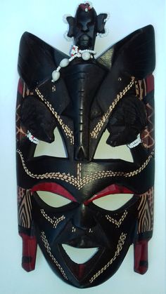 This wooden mask was made in Africa by the Maasai tribe of Kenya it is 11.5 inches/30cm in height. Please note that each mask is unique and there might be slight differences in shape size and color. Traditional Black Masks And Prosthetics For Carnival, Handmade Traditional Mask, Artistic Handmade Black Masks, Wooden Mask, African Masks, Maasai, Kenya, South Africa, Mask