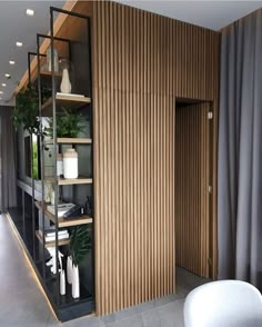 a room with wooden walls and shelves filled with plants