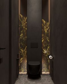 a black toilet sitting in the middle of a bathroom next to a plant filled wall