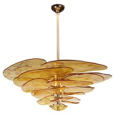 a chandelier hanging from the ceiling in an art deco style with glass petals