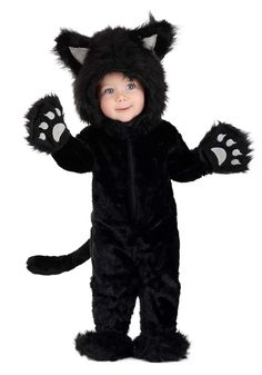 a little boy in a black cat costume