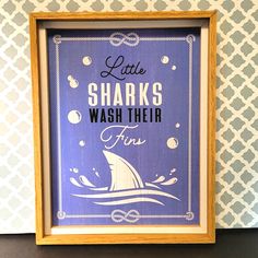 there is a sign that says little sharks wash their fine soaps on the wall