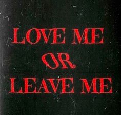 the words love me or leave me written in red ink on a black paper background