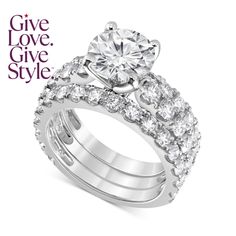 a white gold engagement ring and wedding band set with an oval center stone surrounded by round brilliant cut diamonds