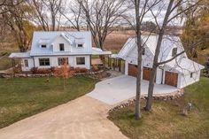 this is an aerial view of a house in the country side with lots of trees and grass