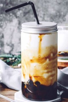 an iced drink in a mason jar with a black straw sticking out of the top