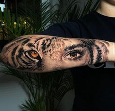 a man with a tiger eye tattoo on his arm