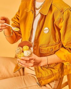 a woman sitting on a chair eating waffles and ice cream