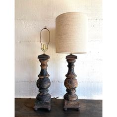 two wooden lamps sitting on top of a table