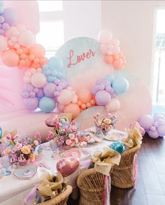 a table set up with balloons and flowers