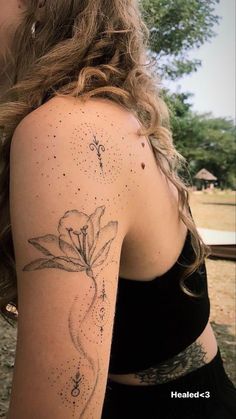 a woman with a flower tattoo on her arm