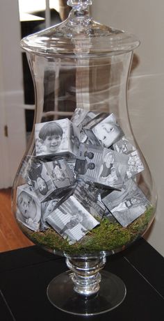 a glass jar filled with money sitting on top of a table