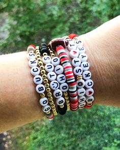 Ohio Bracelet Set 🅾️🏈🏟️ Cheer on your team with this cute bracelet stack 📣 Bracelets are sold individually or as a set Made with clay beads, circle letter beads and 18k gold filled spacers and beads CARING TIPS FOR YOUR JEWELRY ⭐️Treat and store with care. ⭐️ For longevity, avoid exposing your jewelry to water. ⭐️ Avoid having direct contact with lotions, perfumes, sanitizers as these chemicals may cause discoloration of your jewelry. School Spirit Beaded Bracelets With Letter Beads For Gifts, Ohio State Clay Bead Bracelet, Football Team Clay Bead Bracelets, Football Clay Bead Bracelets, Ohio State Ankle Bracelet, Team-colored Letter Beads Bracelets For Sports, Ohio State Bracelet, Team Bracelets, Football Bracelet