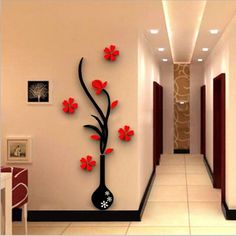 the hallway is decorated with red flowers and black vases