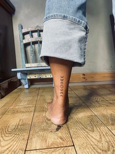 a woman's foot with the word hope tattooed on it