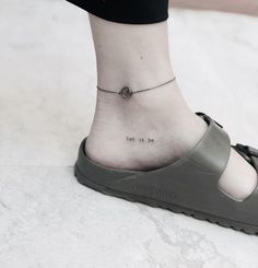 a woman's foot with a small tattoo on her ankle that reads, i am the one