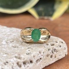 Estate/ vintage 14KT yellow gold ring with genuine, oval cut, emerald and concave wide band. Prong set emerald, and glue has been added to stabilize the stone. Great piece as an engagement/anniversary piece or even as a pinky ring due to its current size. Size 5 Can be resized for an additional fee Weight: 3.2 grams 9mm wide band, tapered back Genuine, bright green, oval-cut emerald measures: 7mm x 4.95mm Abrasions to the stone Estimated 1.00 carat genuine, emerald Stamped 14K and hallmarked Saint Jewelry, Wide Band Ring, Green Oval, Wide Band Rings, Pinky Ring, Engagement Anniversary, Yellow Gold Ring, Wide Bands, Bright Green