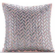 a grey and pink pillow on a white background