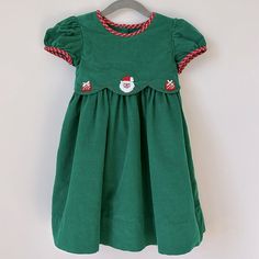 22” Dress Length 10.5” Across Underarms 10” Across Shoulders 100% Cotton Green Cotton Winter Dresses, Winter Cotton Dress With Embroidery, Winter Embroidered Cotton Dress, Casual Cotton Christmas Dress, Cute Cotton Holiday Dresses, Green Short Sleeve Christmas Dresses, Casual Green Christmas Dress, Green Cotton Holiday Dress, Winter Holiday Cotton Dress