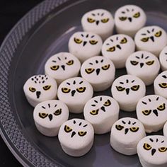 white marshmallows with black eyes and yellow eyes are arranged in the shape of an owl