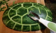 a cutting board with a knife on top of it next to a cut up watermelon