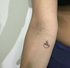 a woman's arm with a small tattoo on the left side of her body