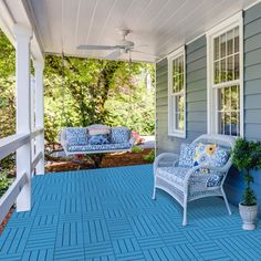 a porch with blue and white furniture on it