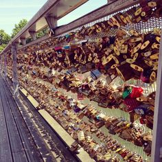 many padlocks are attached to the fence