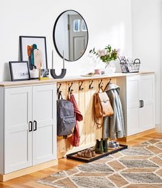 an image of a room with some clothes hanging on the wall and a mirror above it