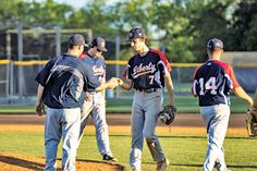 some baseball players are standing on the field