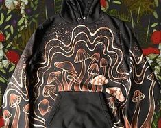 a black hoodie with an image of mushrooms on it