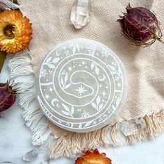 a frisbee sitting on top of a table next to flowers and other items