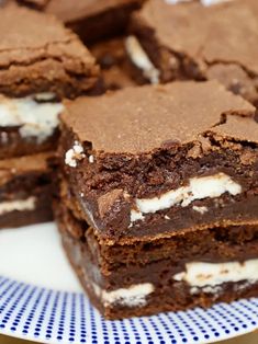 several brownies are stacked on top of each other with marshmallows and chocolate