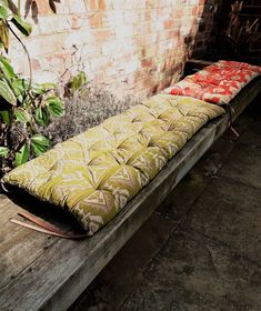 a bench that has some cushions on it