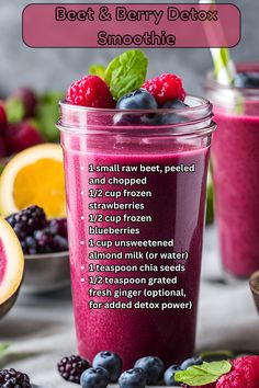 a smoothie with berries, raspberries and blueberries in it on a table