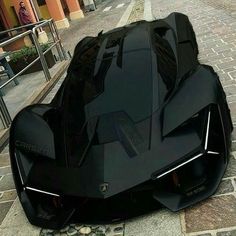 a futuristic looking car is parked on the street