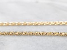 This chain is in excellent condition, and it's a piece that is going to be useful and worn frequently for years to come. The style of the chain is loose enough to allow for movement when worn, preventing the chain from being tangled and feeling very nice on the skin. The link style is known as a wheat chain, due to it's straight, yet ever so slightly curved links that when woven together look like the tops of wheat! Metal: 14K Yellow Gold Width of Chain: 2.8 mm Length of Chain: 22 Inches Marks: Jewelry Basics, Chain Layering, Basic Jewelry, Yellow Gold Necklace, Layering Necklace, Chain Jewelry, Hand Engraving, Eternity Bands, Vintage Necklace