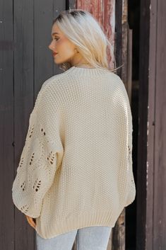 This Crochet Sleeve Pullover Sweater in Cream offers a chic blend of texture and style! Featuring long balloon sleeves with intricate crochet detailing, this sweater adds a unique flair to any outfit. It has a round neckline with ribbed detailing at the neckline, cuffs, and hem, enhancing its cozy feel. Designed with an oversized fit, it's perfect for layering and everyday comfort. Style with jeans, ankle booties, and a wide brim hat for an elevated chic outfit. Trendy Textured Knit Sweater With Balloon Sleeves, Trendy Textured Knit Balloon Sleeve Sweater, Trendy Balloon Sleeve Textured Knit Sweater, Oversized Pointelle Knit Chic Top, Chic Oversized Pointelle Knit Top, Cozy Open Knit Cropped Sweater For Fall, Casual Textured Knit Sweater With Balloon Sleeves, Trendy Chunky Knit Sweater With Balloon Sleeves, Casual Sweater With Textured Knit And Balloon Sleeves